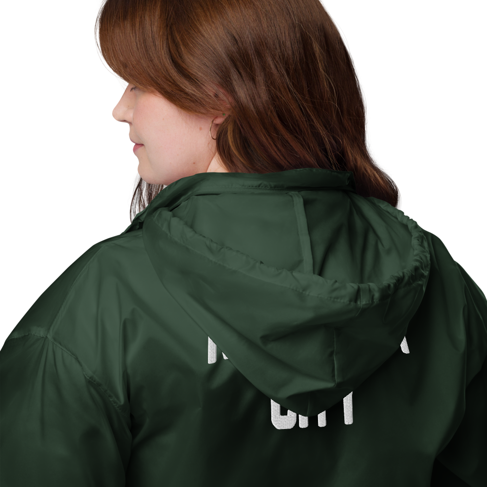 Person wearing a green raincoat with visible branding on a white background